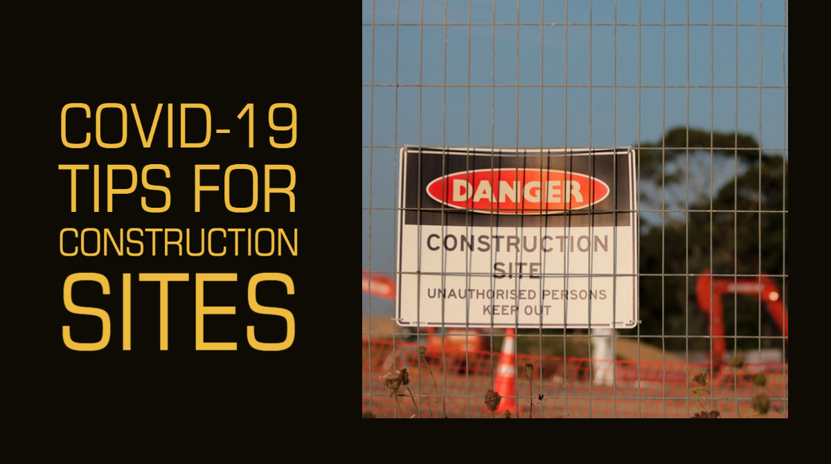 A construction site can be seen through the wire mesh of a metal fence, from which a sign hangs that reads "DANGER. Construction Site. Unauthorised persons keep out."