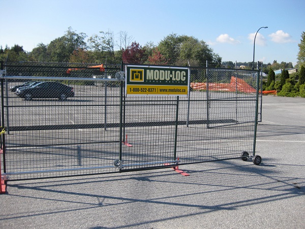 A sliding temporary gate constructed from steel mesh fence panels.