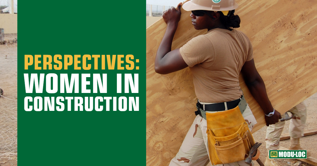 A female construction worker carrying plywood